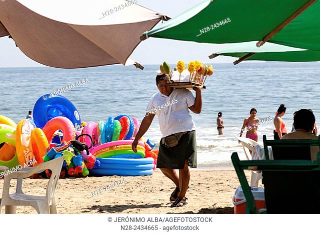 Woman selling fruit. Manzanillo beach. Pacific Ocean. Colima. Mexico