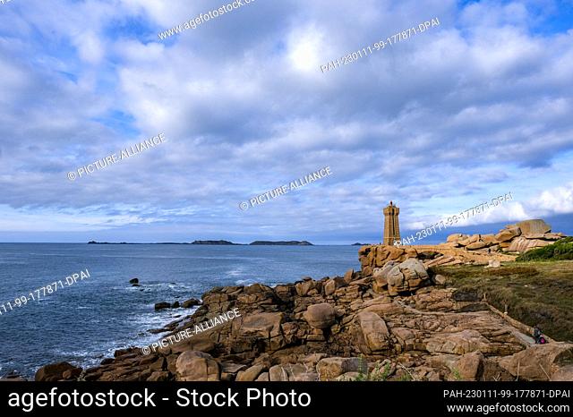 PRODUCTION - 03 October 2022, France, Ploumanach: The Phare de Ploumanach lighthouse on the Cote de Granit Rose coastline