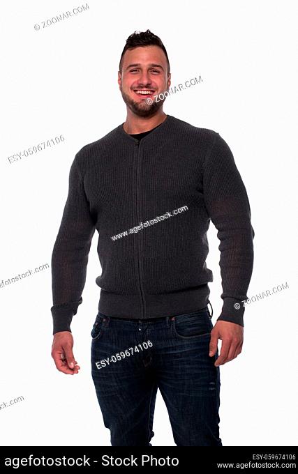 Happy relaxed young man in black shirt, denim jeans and blazer looking at camera with hands in pockets. Full body length portrait isolated over white studio...