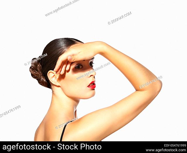 Beautiful woman with red lips making shadow by her hand on the face isolated