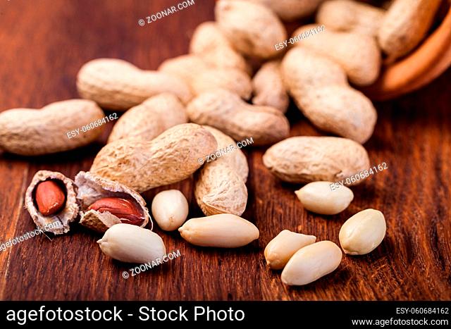 Peanuts isolated on a wooden table