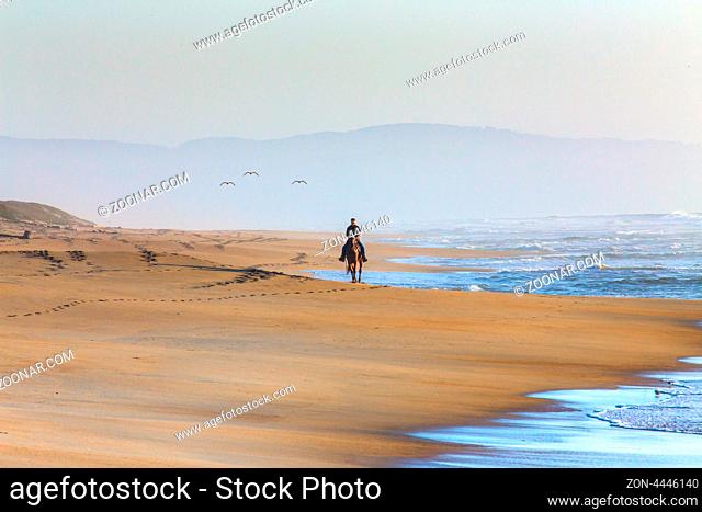 Woman Riding Horse on Beach at Sunset on Salinas State Beach, California.5