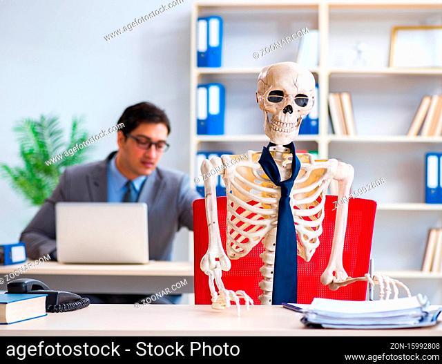 The businessman working with skeleton in office