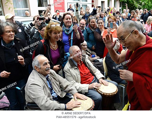 The Dalai Lama (R), spiritual leader of Tibet, thanks residents of the neighboring retirement home for their drum welome outside of Tibet House in Frankfurt...