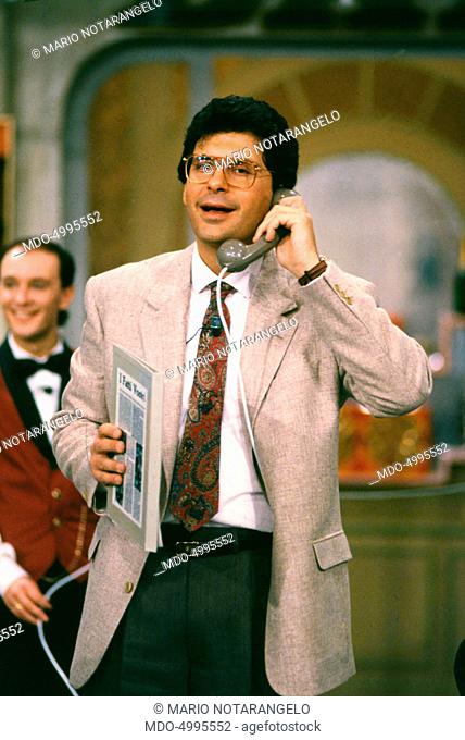 Italian TV host Fabrizio Frizzi speaking over the phone in the TV show I fatti vostri. 1990