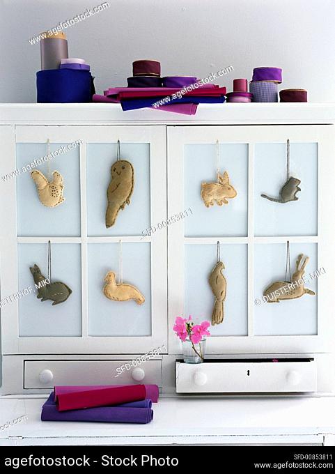Small fabric animals decorating a cupboard