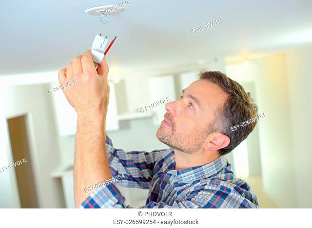 Attaching a smoke alarm to the ceiling