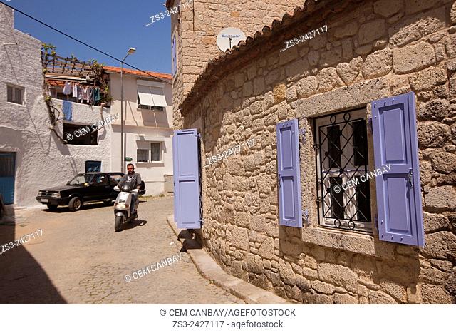 Man riding on a bike in front of the traditional house in Alacati town, the historic centre of Zeytineli Koeyue, Cesme, Izmir, Turkey, Europe