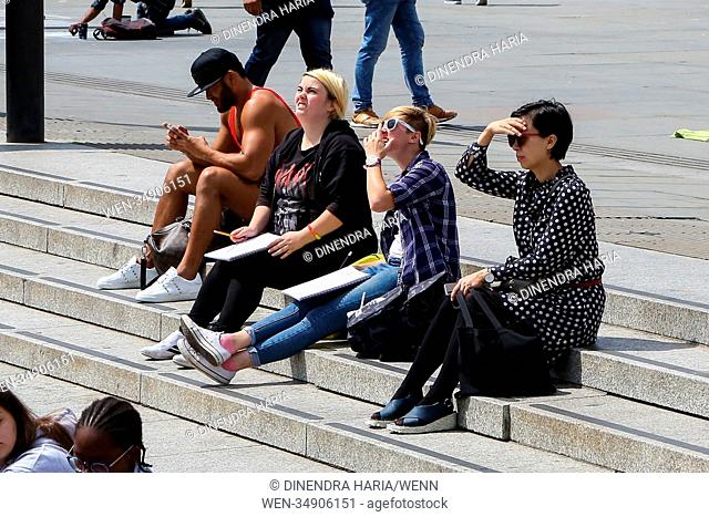 Londoners and tourists enjoy the warm sunshine in Trafalgar Square. Met Office issues yellow warning for flooding, thunderstorms and heavy downpours to end...