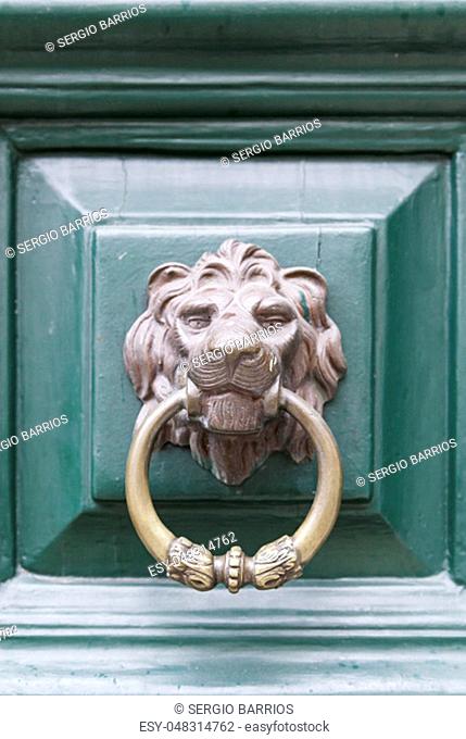 Caller shaped golden lion, detail of an ancient decorated door, ancient art