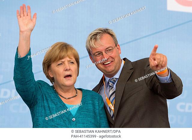 German chancellor Angela Merkel (CDU) waves onstage at an election campaign event in East Frisian fisher village Neuharlingersiel, Germany, 19 July 2013
