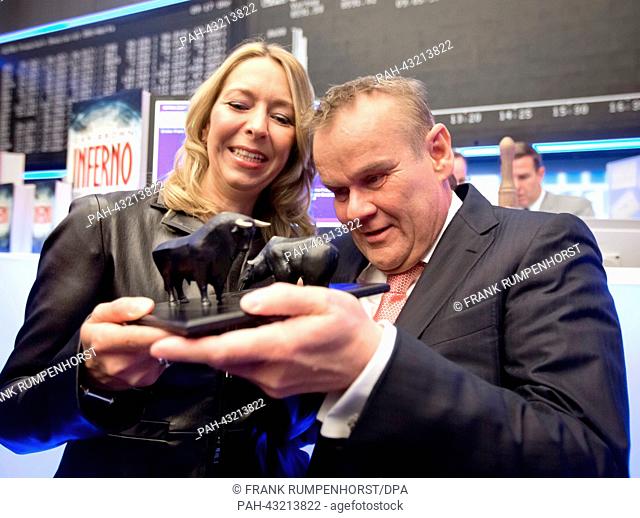 Publishers Birgit and Stefan Luebbe view the tiny sculptures of bull and bear they received as a present from the Deutsche Boerse Group shortly after the...