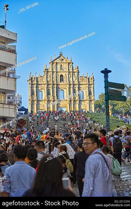 Crowd of tourists at the Ruins of Saint Paul's, a 17th-century Catholic religious complex, now one of Macau's best known landmarks. Macau, China