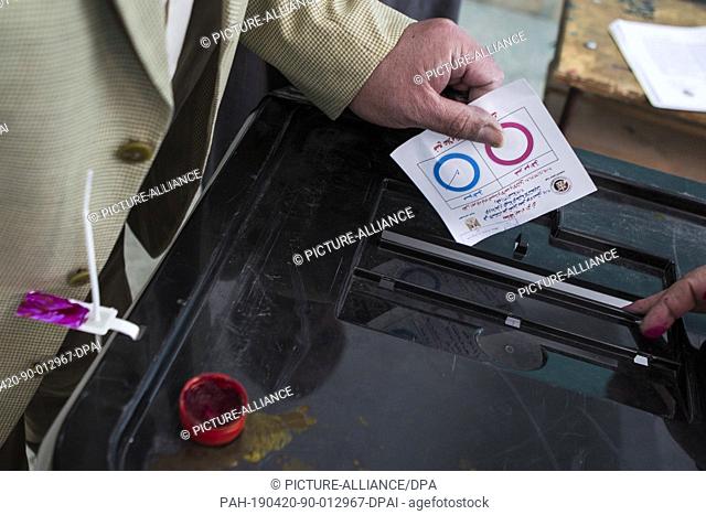 20 April 2019, Egypt, Cairo: A man casts his ballot on the first day of the national referendum on the constitutional amendments extending the presidential term...