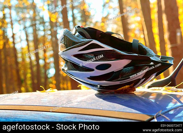 Bicycle helmet on a background of forest, a bike helmet on a blue background