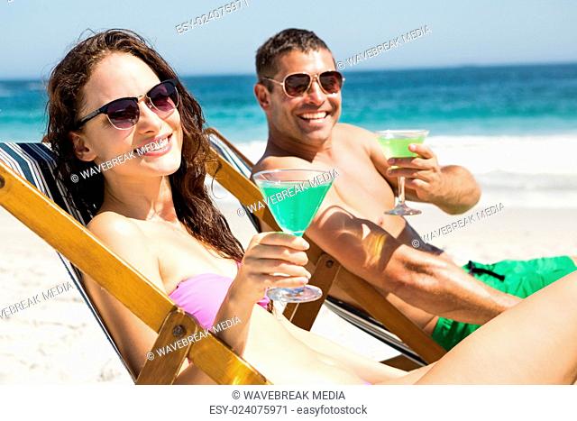 Couple sitting and drinking cocktails