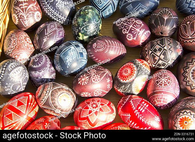 Easter eggs painted on table sold at market outdoor street fair illuminate sunlight