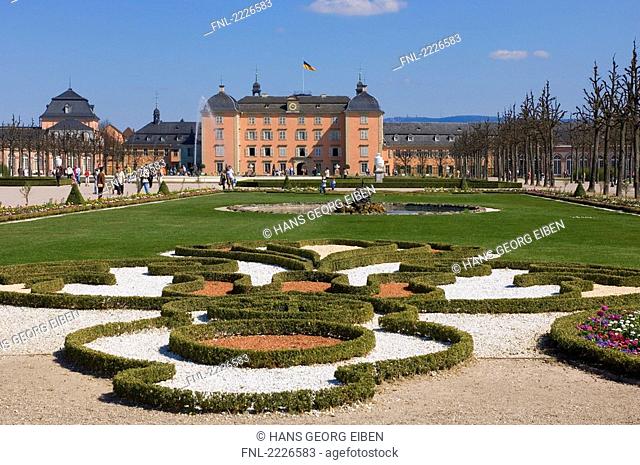 Tourists at formal gardens of palace, Schwetzingen Castle, Baden-Wuerttemberg, Germany