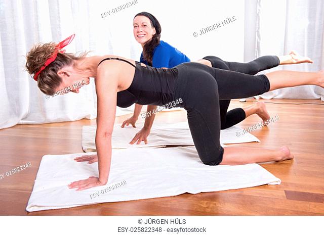 two attractive women doing their workout