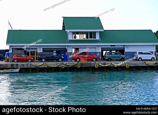 Ferry harbour with cars parked at the docks, St Anne's Bay, Praslin Island, Seychelles