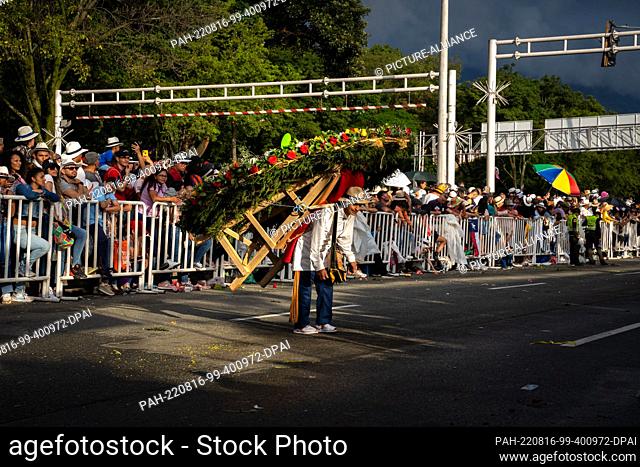 15 August 2022, Colombia, Santa Elena Antioquia: A silletero man in typical costume moves around as part of the Medellin Flower Festival