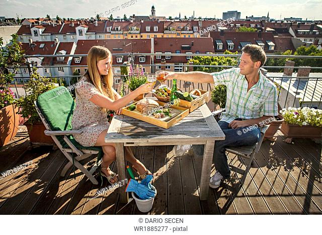 Young Couple Relaxing On Balcony, Munich, Bavaria, Germany, Europe