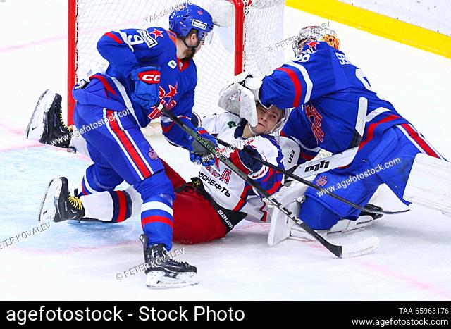 RUSSIA, ST PETERSBURG - DECEMBER 21, 2023: SKA goaltender Nikita Serebryakov (R), supported by Sergei Sapego (L), defends against CSKA's Sergei Plotnikov in a...