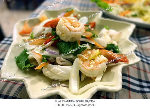A spicey seafood salad made of squid and prawns .(Yam Taleh)is seen on a table at a restauarant in Karon Beach, Thailand 18 March 2016