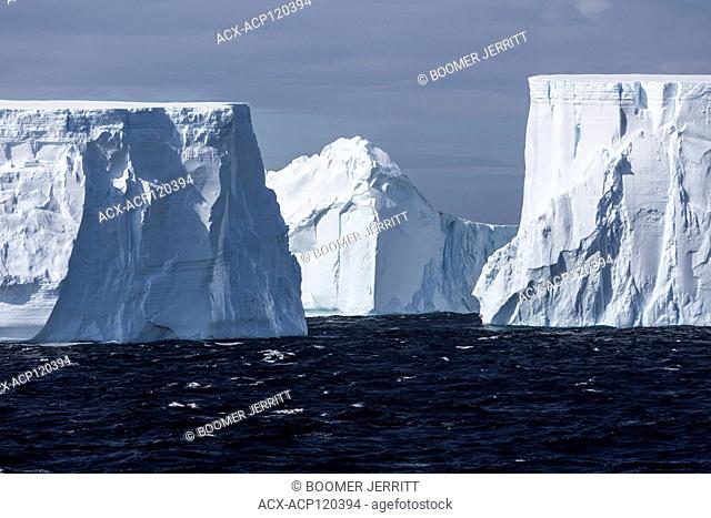 Incredibly large tabular icebergs float through the antarctic Sound near the top of the Antarctic Peninsula, Antarctica