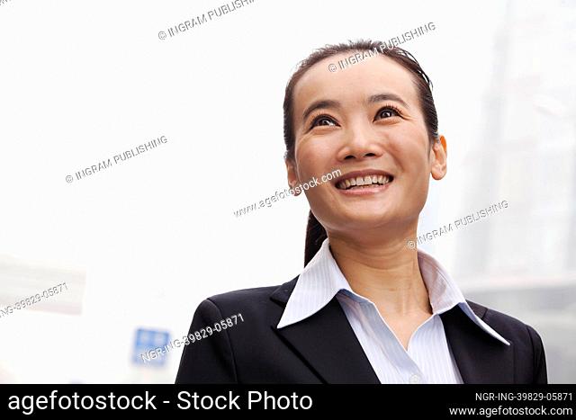 Young Businesswoman Smiling and Looking into the Distance