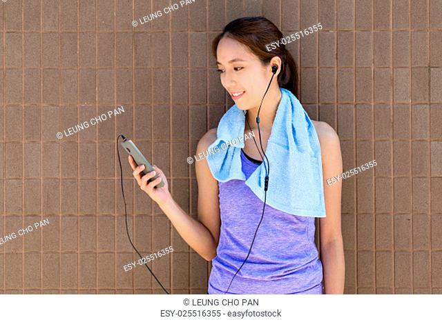 Young woman with sportwear and listen to music