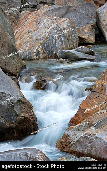 Verzasca river course, water flowing through colored banded rocks, Verzasca valley, Switzerland, canton Ticino