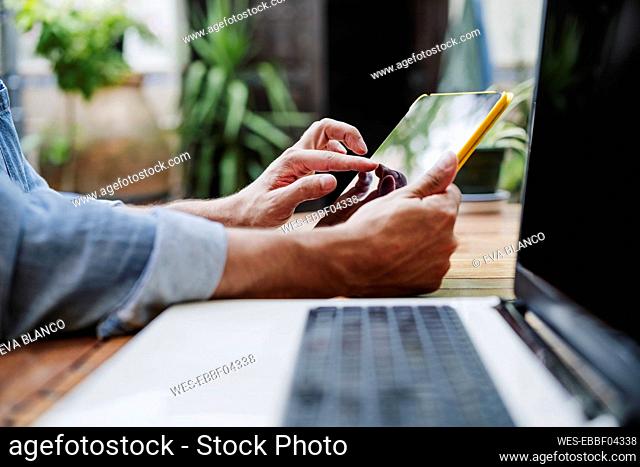 Male freelancer using digital tablet at backyard