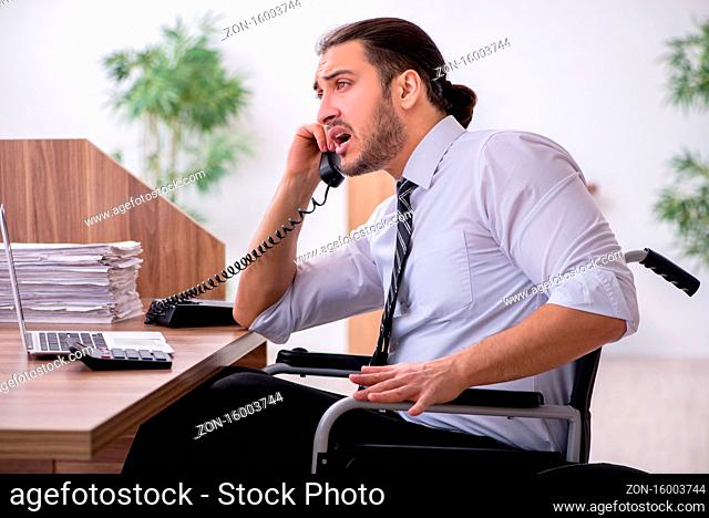Young disabled employee suffering at the workplace