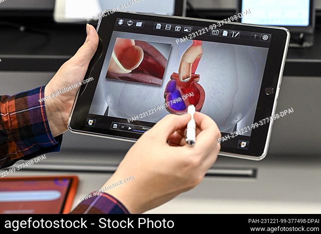 13 December 2023, Berlin: A digital tool is shown on a tablet in the e-health show practice of the Berlin Association of Statutory Health Insurance Physicians