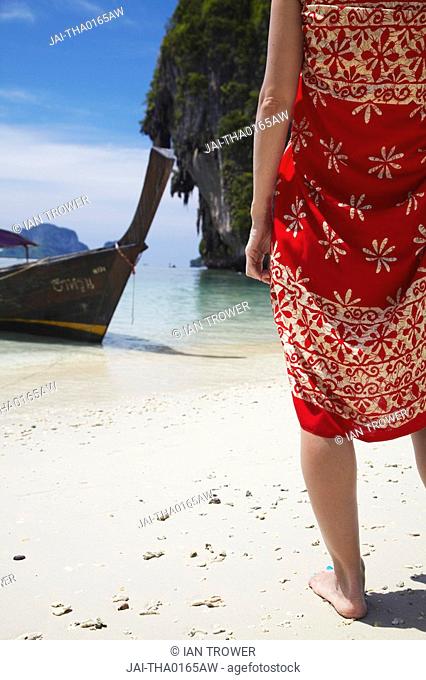 Woman wearing sarong on Hat Tham Phra Nang beach, Railay, Krabi Province, Thailand MR