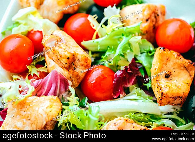 Chicken salad with cherry tomatoes, lettuce and veggies for healthy diet, food delivery service and order online concept