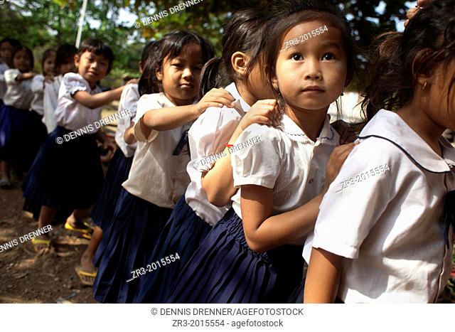 School girls line up after recess in a village school near Battambang, Cambodia