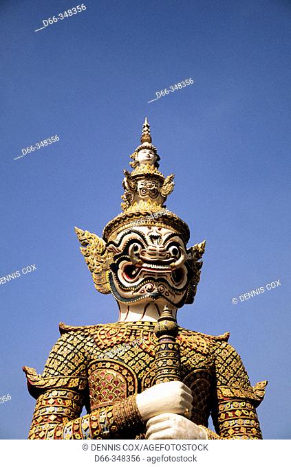 Demon Yaksha statue guarding Wat Phra Keo temple on grounds of the Grand Palace. Bangkok, Thailand