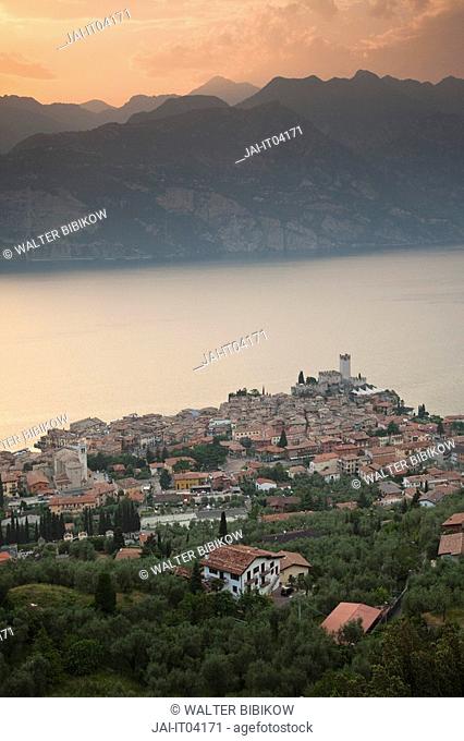 Italy, Veneto, Lake District, Lake Garda, Malcesine, aerial town view from Monte Baldo, sunset