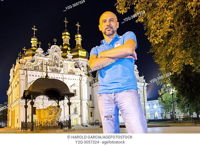 Man standing near the Orthodox cathedral Kyiv Pechersk Lavra in Kiev, Ukraine