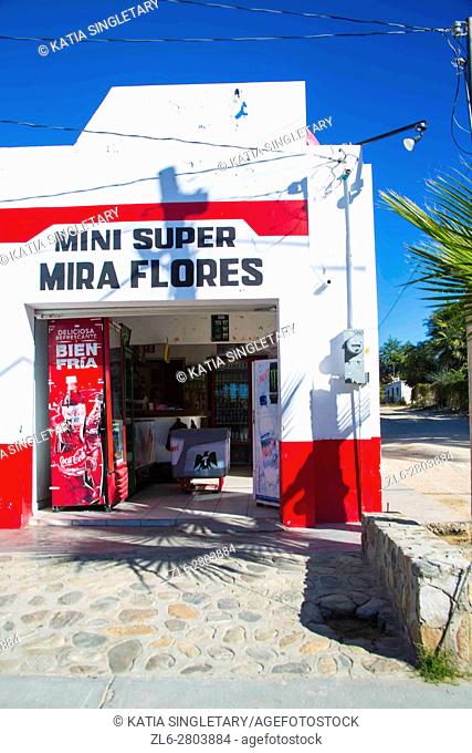 Mini tiny supermarket called' mini Miraflores' set in a white house in the middle of nowhere outside of Cabo San Lucas. Blue sky, sunny day in Cabo San Lucas