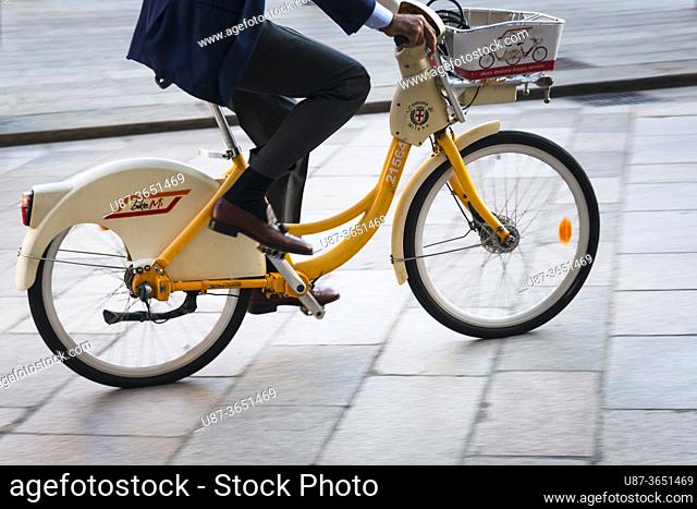 Italy, Lombardy, Milan, Businessman Riding on a Rental Bike