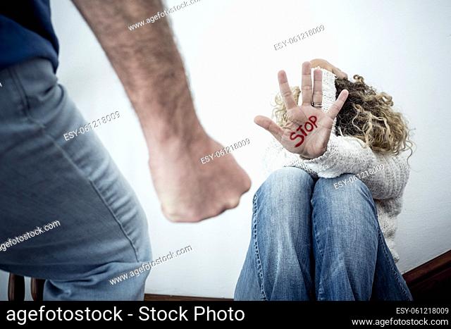 Stop Domestic violence aggression concept with hidden woman protecting herself from angry man ready to hit her - home problems people and females needs...