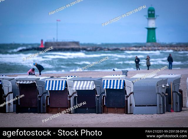 11 May 2020, Mecklenburg-Western Pomerania, Rostock: Empty beach chairs of a rental company stand on the beach of Warnemünde