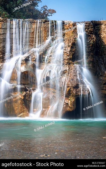 Smooth Long Exposure of Waterfall. Creamy Beautiful waterfall falling off a cliff in the mountas