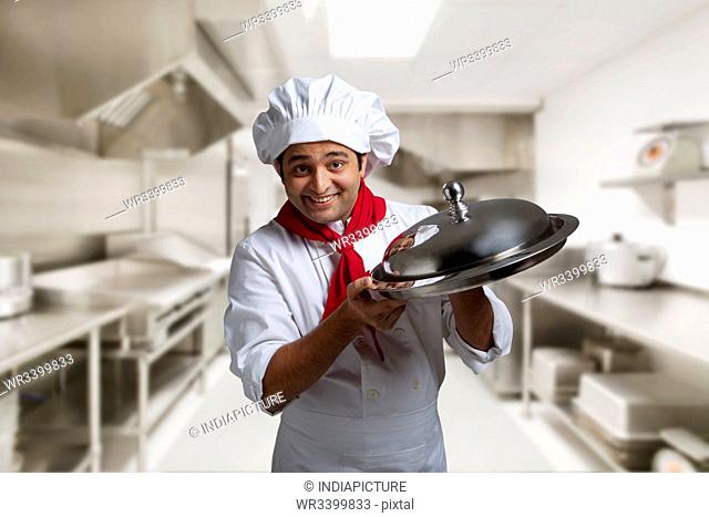 Portrait of a chef with a tray