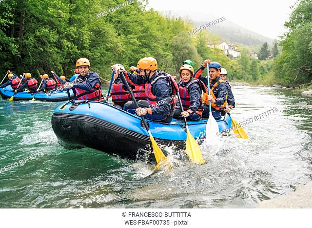 Group of people rafting in rubber dinghy on a river