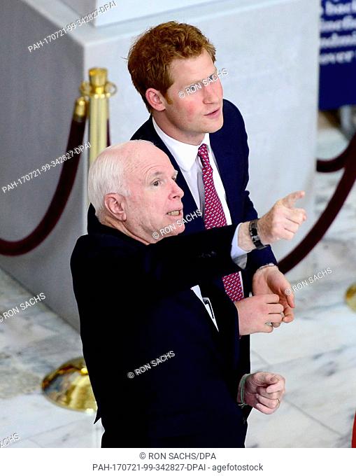 Escorted by United States Senator John McCain (Republican of Arizona) Prince Harry visits an exhibition in the Russell Senate Office Building on Capitol Hill in...