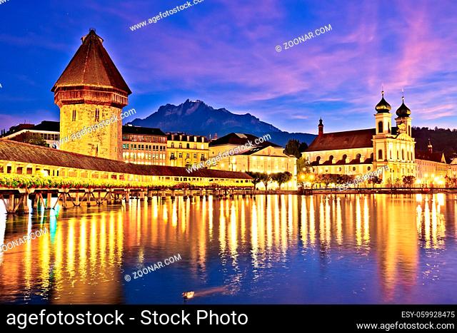 Luzern Kappelbrucke bridge and church with Pilatus mountain background evening view, central Switzerland